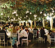 ceiling decorated with greenery and thousands of candles