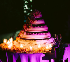 Cutting of the cake with candles and romantic lighting