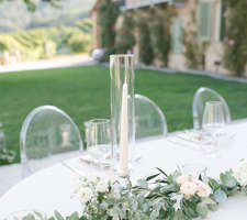 Wedding table decor details - tapers and green garland